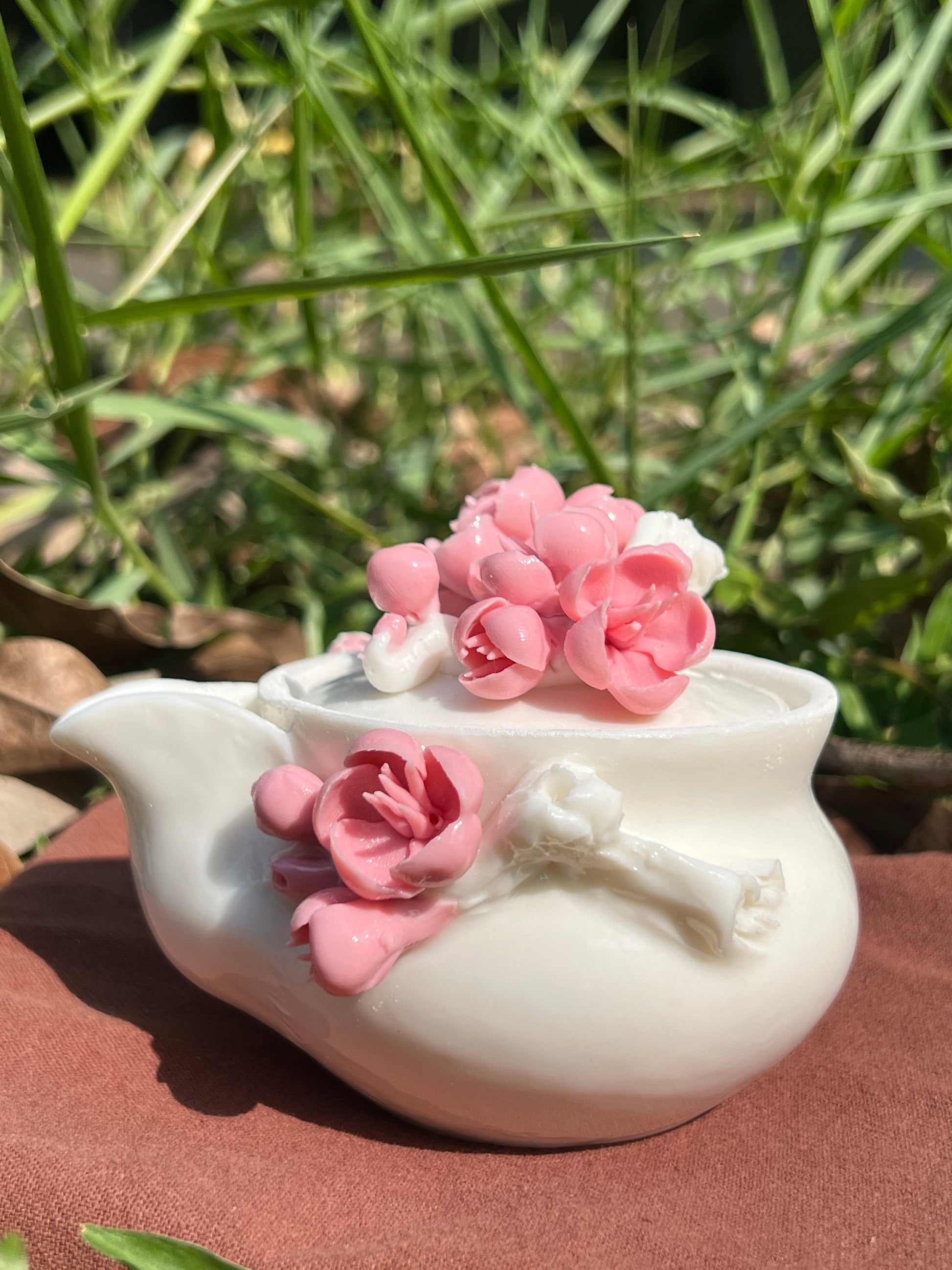 this is a woodfired white fine pottery flower teacup