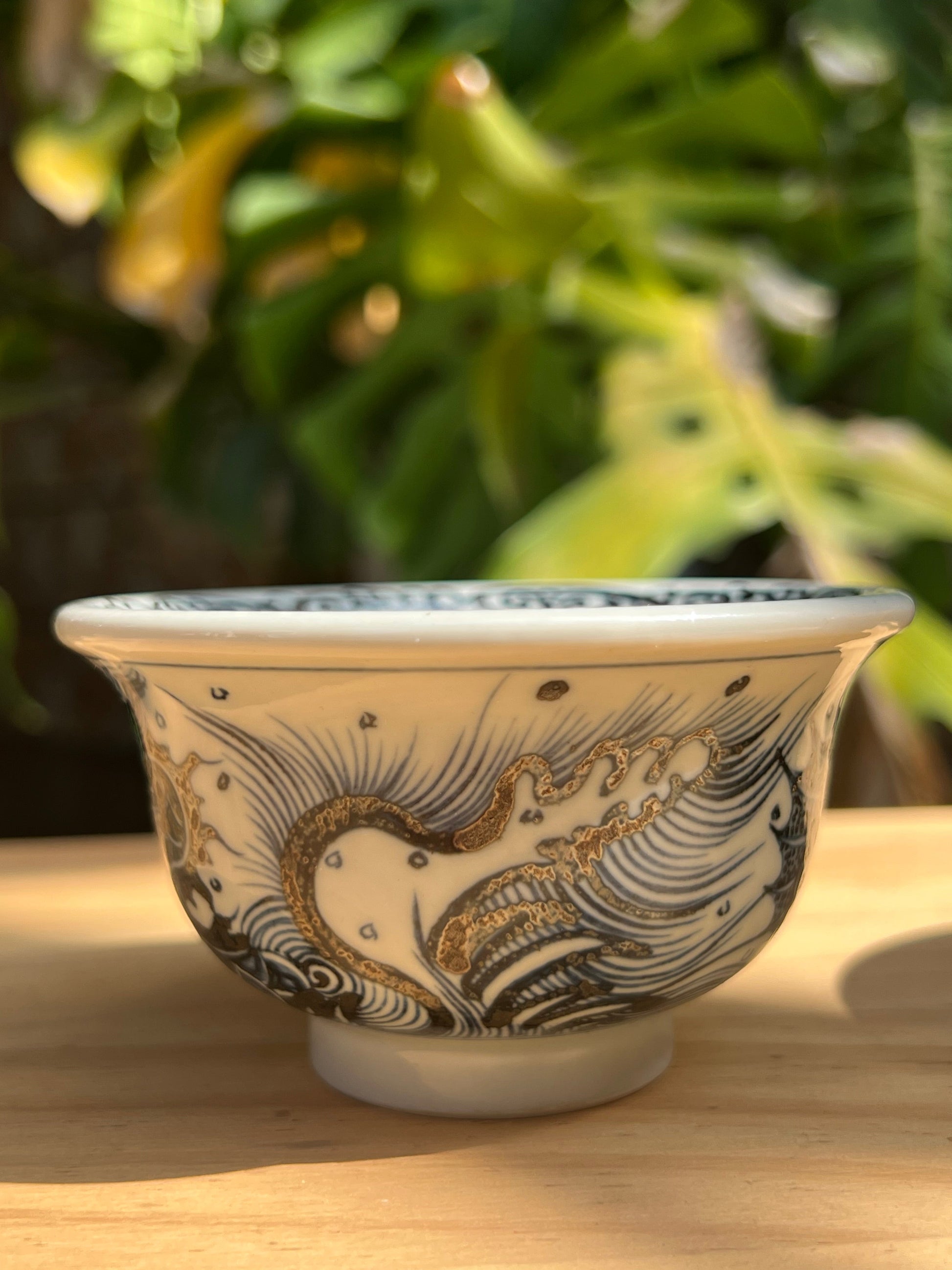 This is a Chinese Jingdezhen blue and white porcelain dragon tea cup