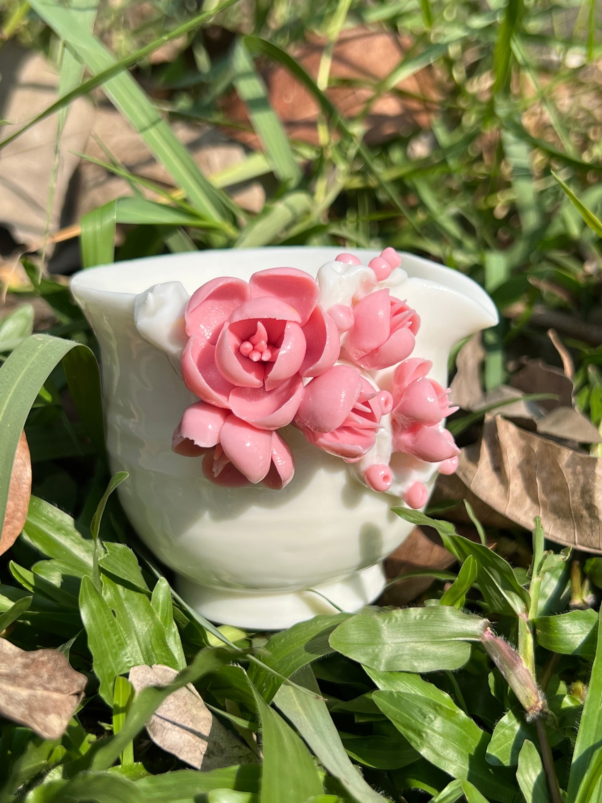 this is a woodfired white fine pottery flower teacup