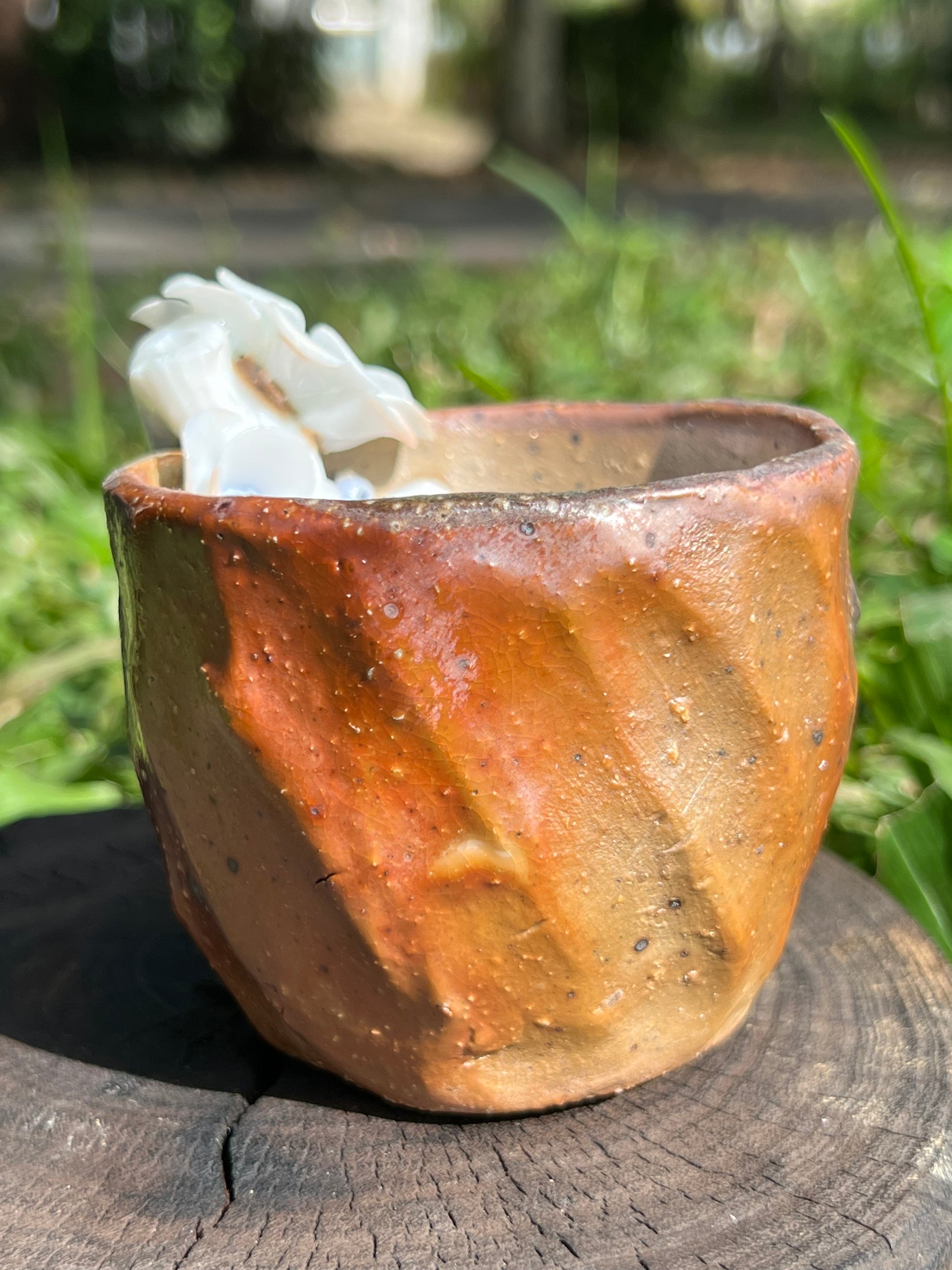 This is a woodfired pottery flower teacup