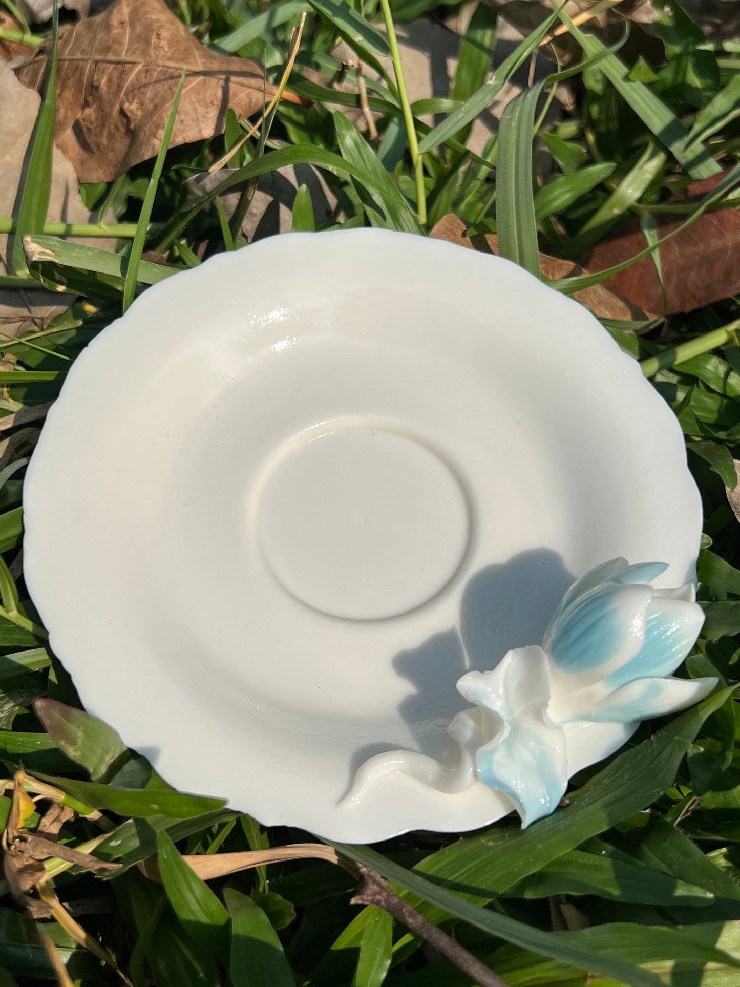 this is a woodfired white fine pottery flower teacup