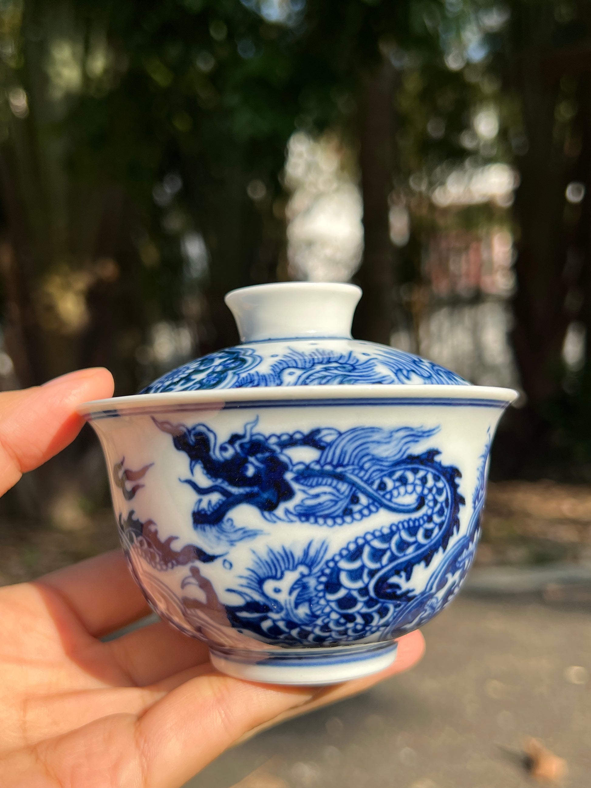 This is a Chinese Jingdezhen blue and white porcelain dragon teapot gaiwan