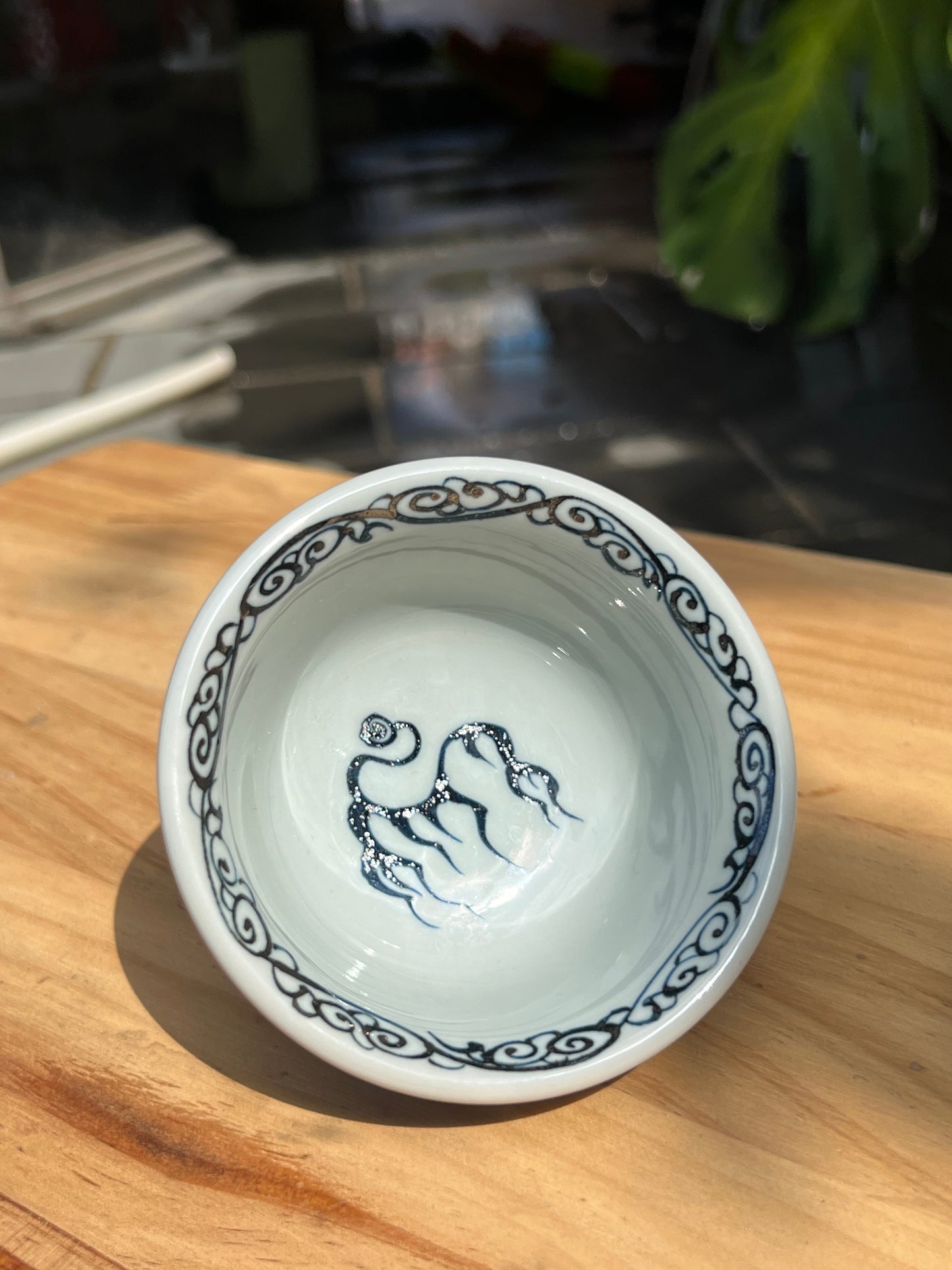 This is a Chinese Jingdezhen blue and white porcelain dragon tea cup