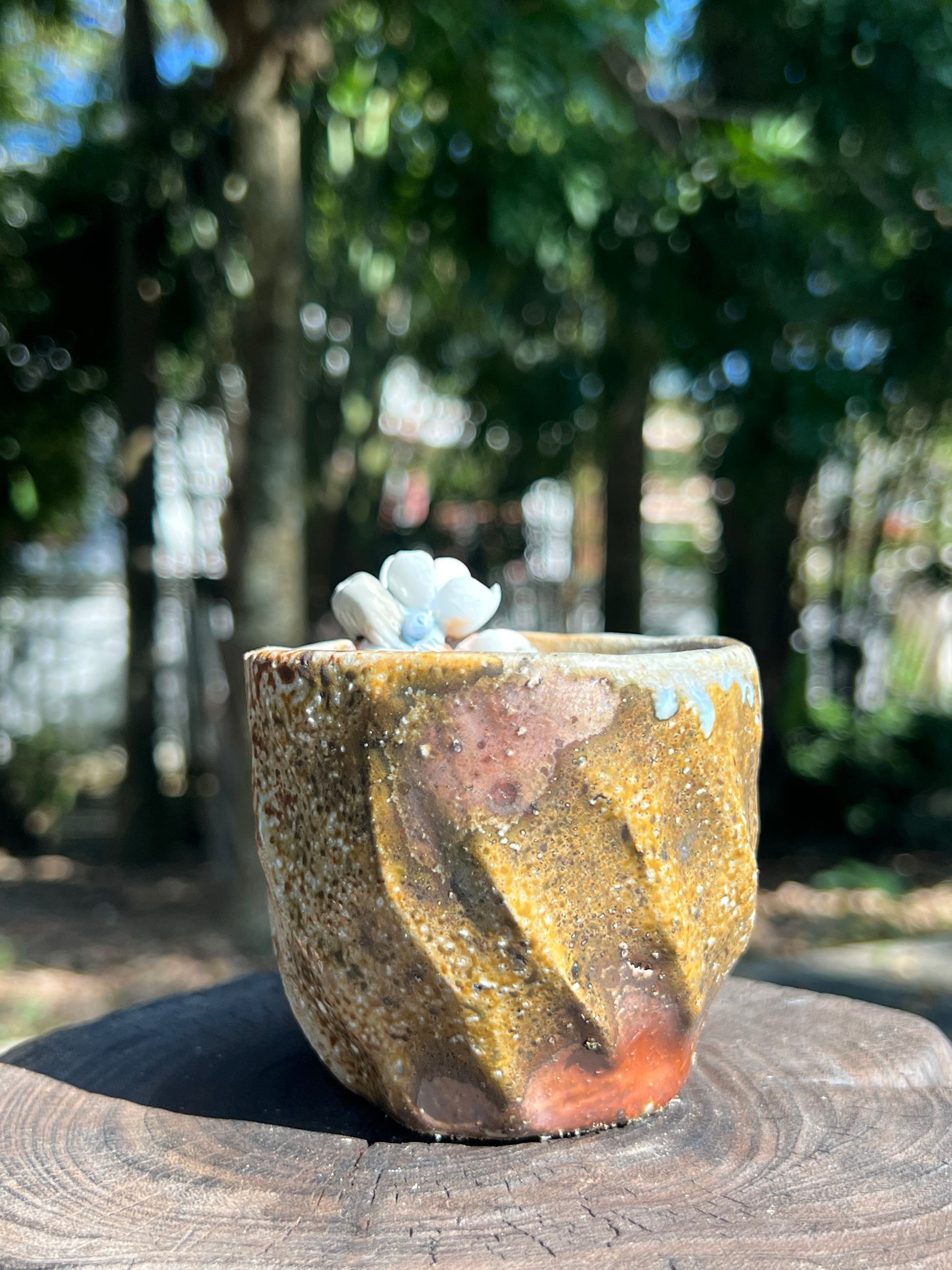 This is a woodfired pottery flower teacup