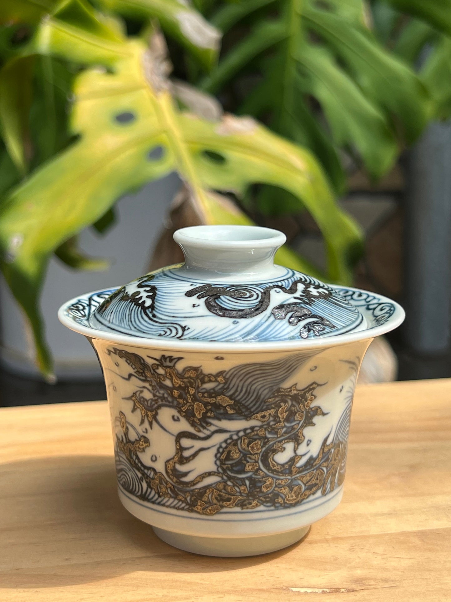 This is a Chinese Jingdezhen blue and white porcelain dragon tea cup