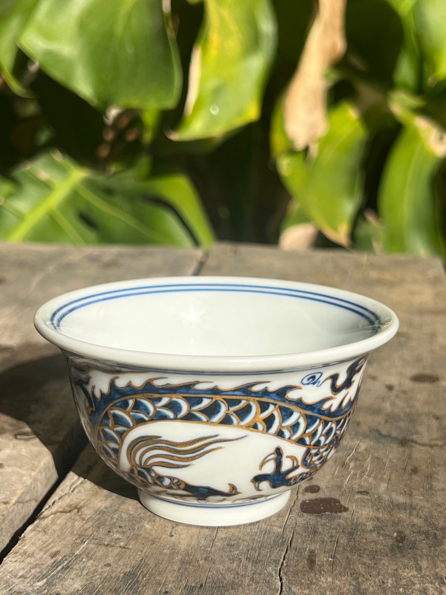 This is a Chinese Jingdezhen blue and white porcelain dragon tea cup