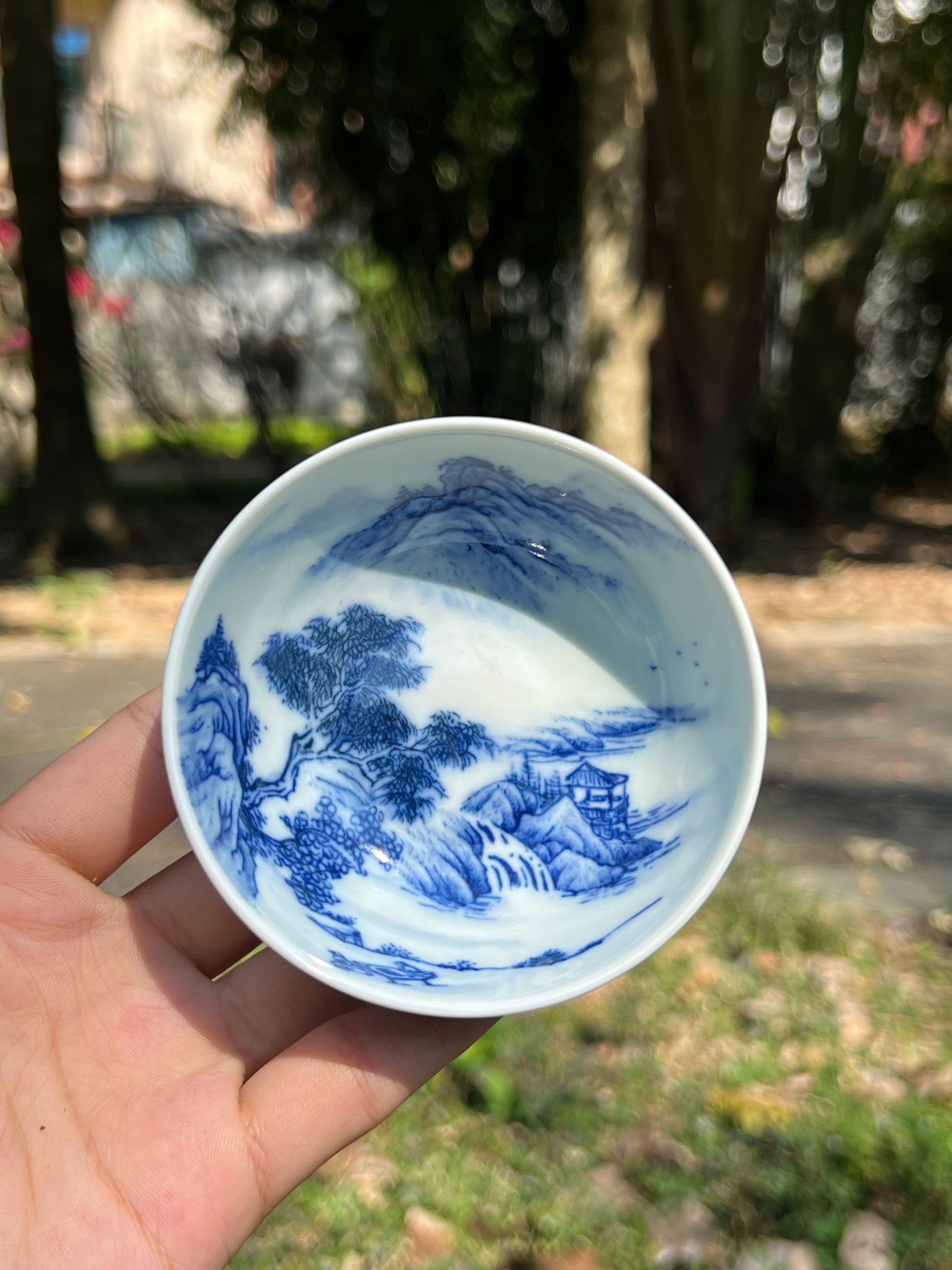 This is a Chinese Jingdezhen blue and white porcelain landscape teacup