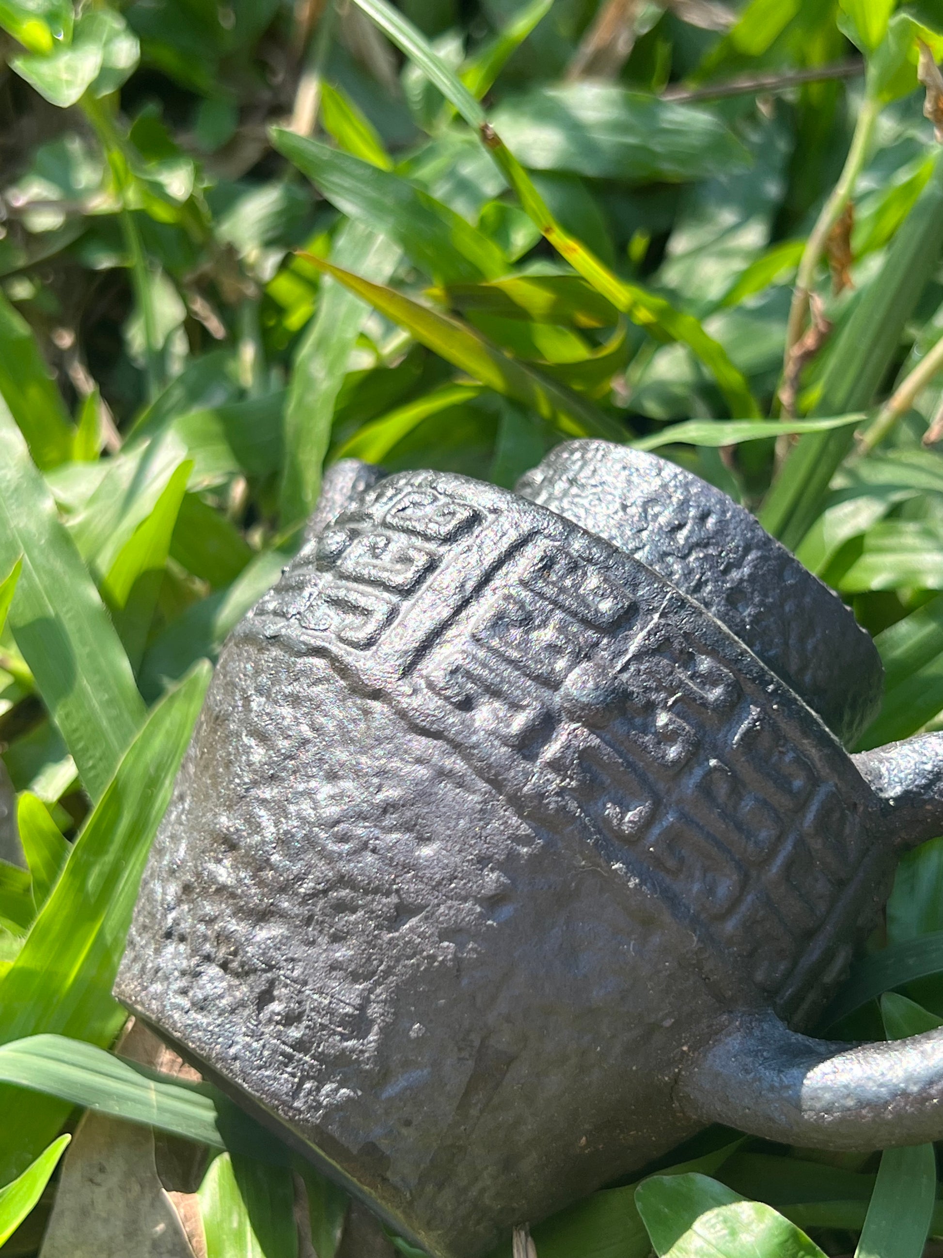 this is a pottery teapot. this is a purple clay teapot