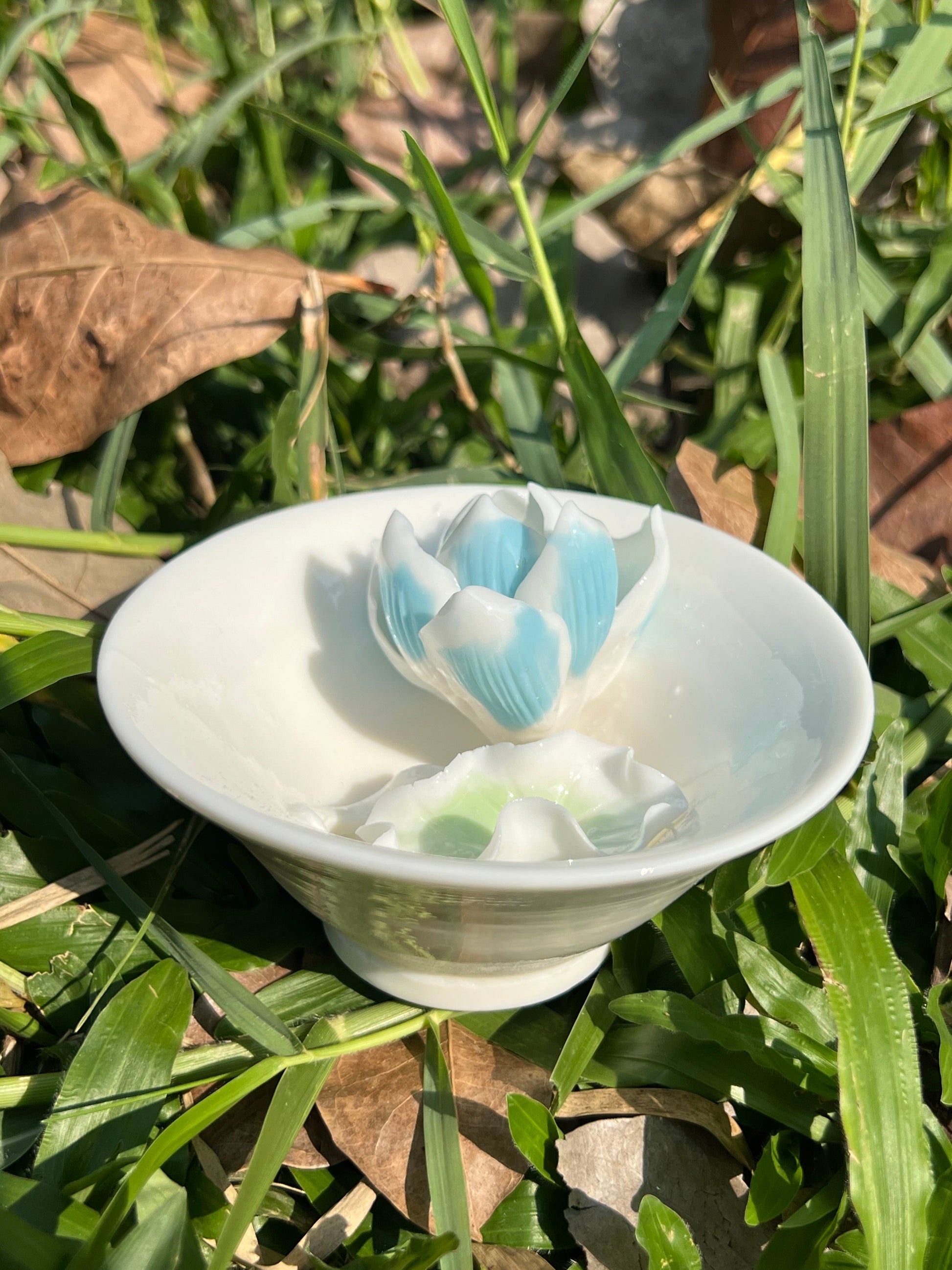 this is a woodfired white fine pottery flower teacup