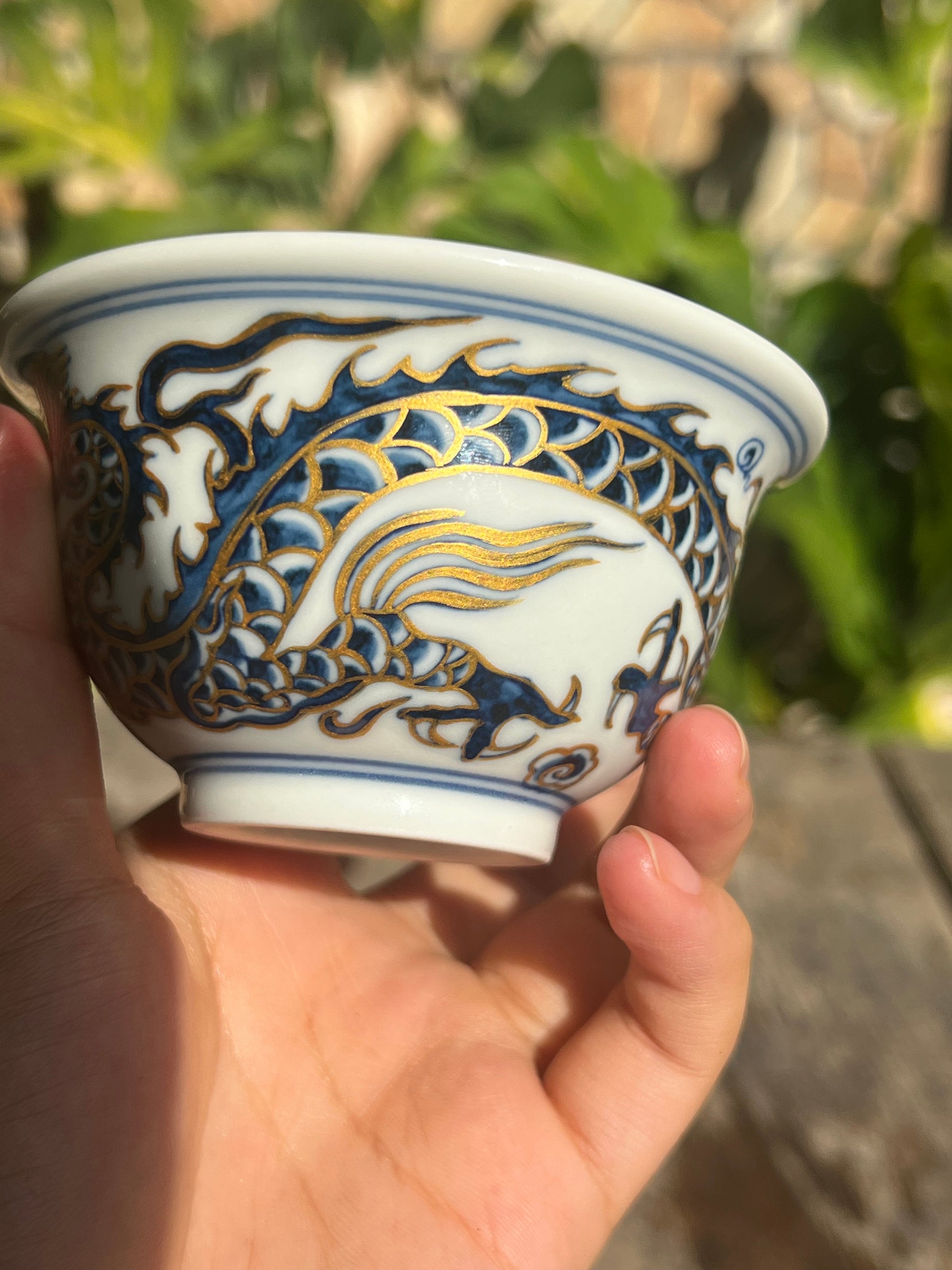 This is a Chinese Jingdezhen blue and white porcelain dragon tea cup