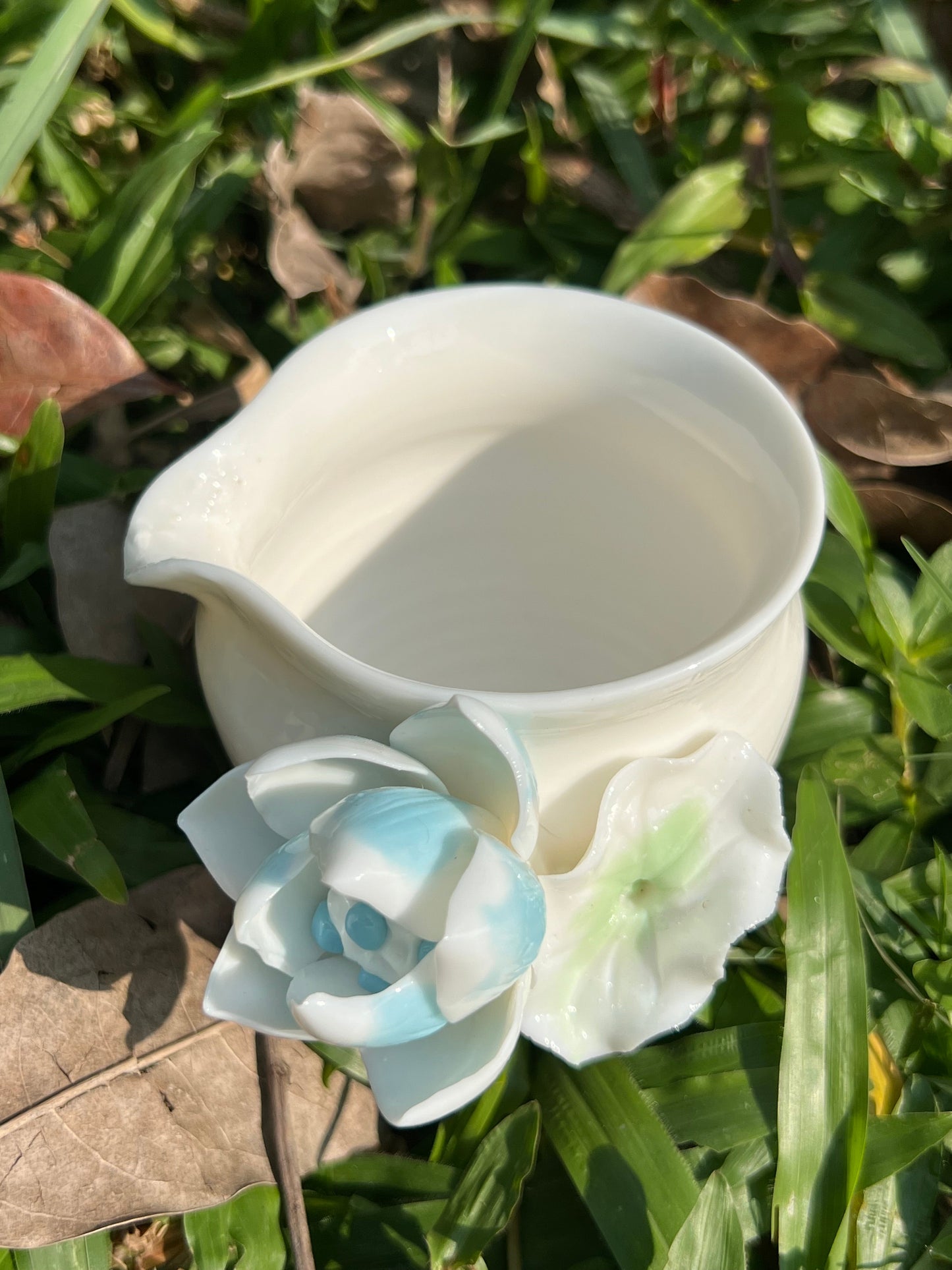 this is a woodfired white fine pottery flower teacup