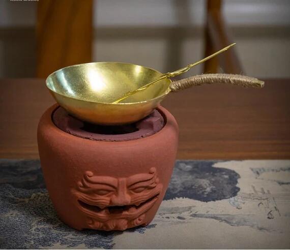 This is a copper tea scoop