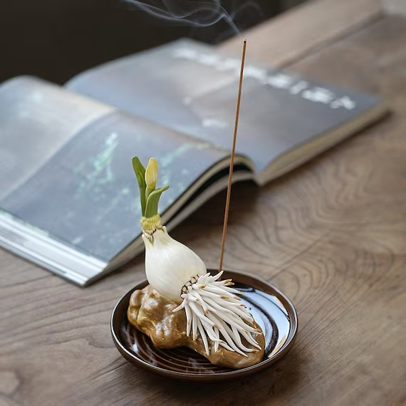 This is a ceramic flower incense holder