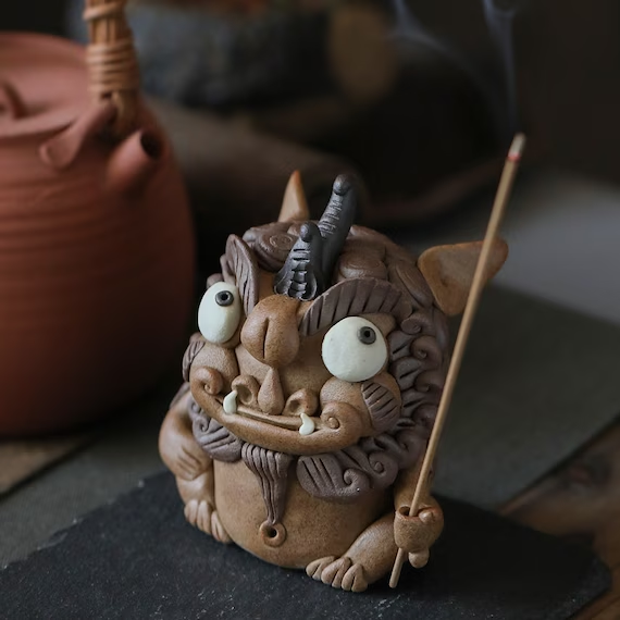 This is a pottery incense holder tea pet