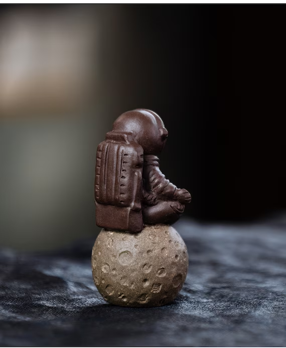 This is a Yixing purple clay meditation astronaut teapet