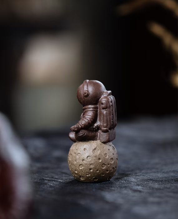 This is a Yixing purple clay meditation astronaut teapet