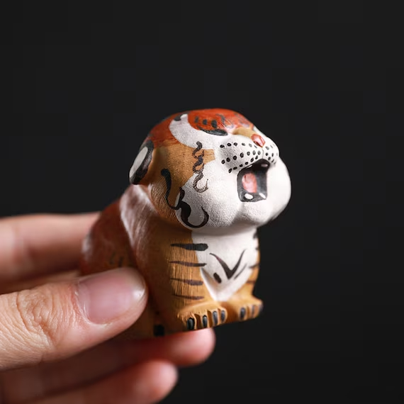 This is a Yixing purple clay tiger teapet