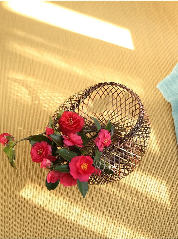 This is a bamboo weaving vase flower arrangement utensil