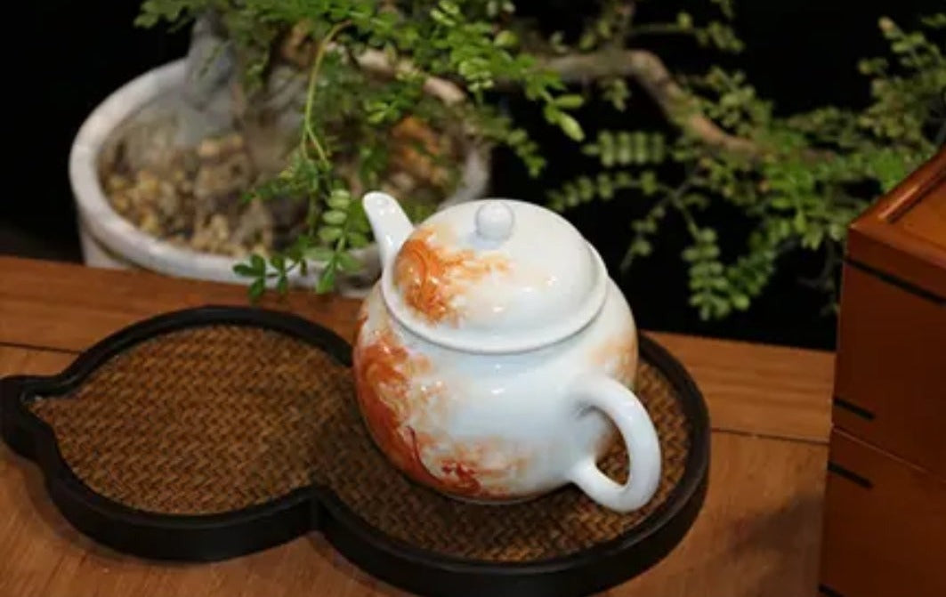 this is a Chinese Jingdezhen alum red dragon phoenix teapot.this is a ceramic teapot