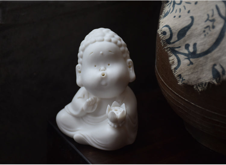 This is a white porcelain buddha teapet incense holder