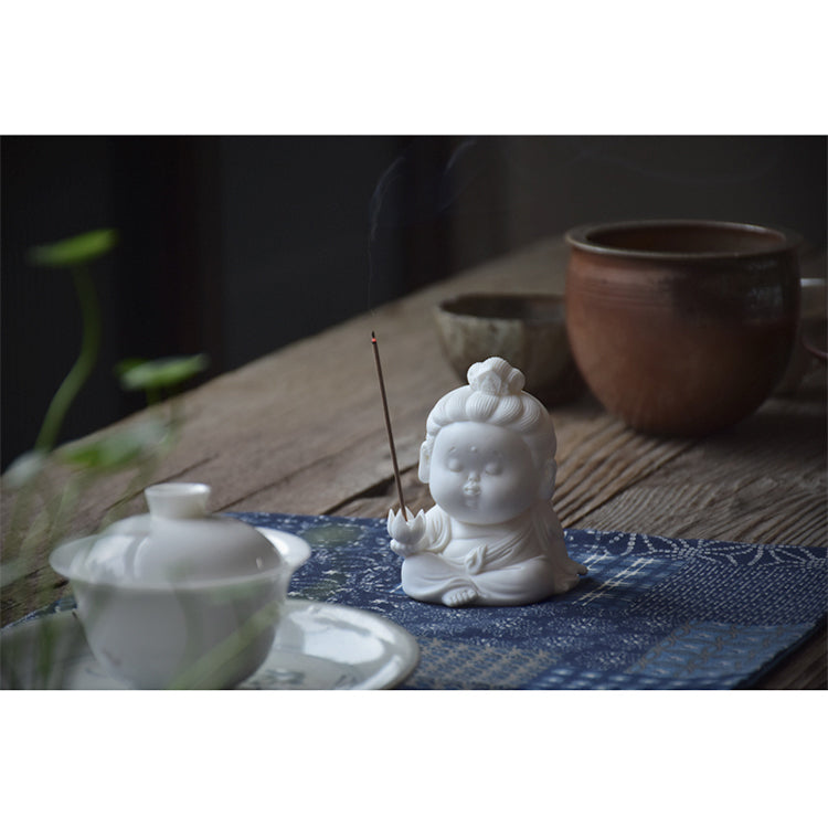 This is a white porcelain buddha teapet incense holder