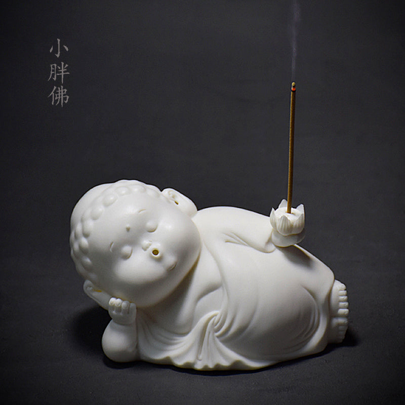 This is a white porcelain buddha teapet incense holder