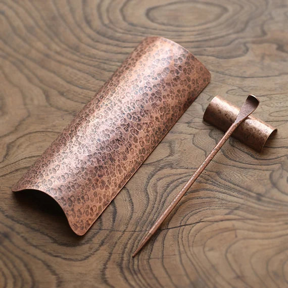 This is a copper tea scoop