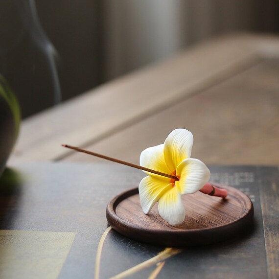 This is a ceramic flower incense holder