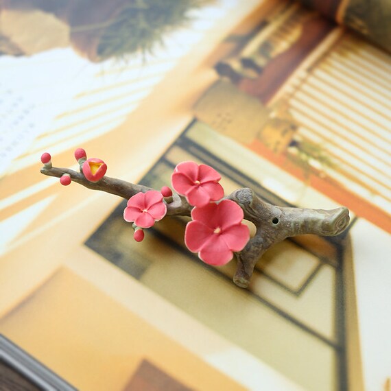 This is a ceramic flower incense holder