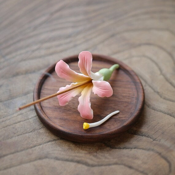 This is a ceramic flower incense holder