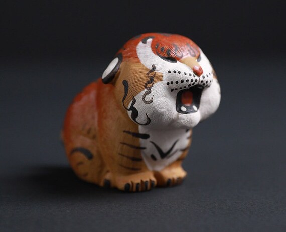 This is a Yixing purple clay tiger teapet