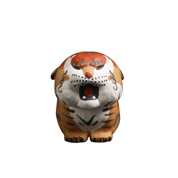 This is a Yixing purple clay tiger teapet