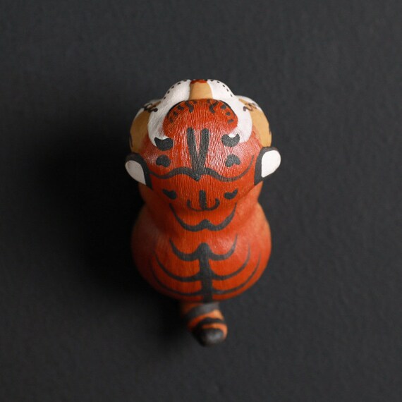 This is a Yixing purple clay tiger teapet