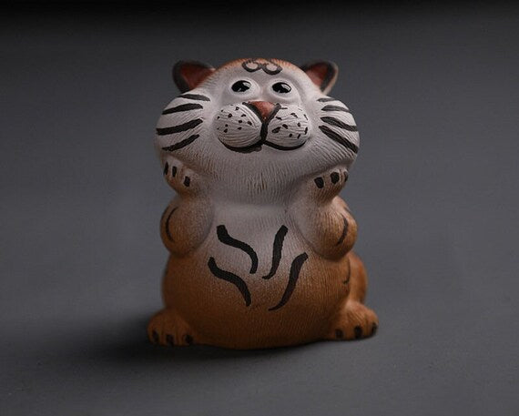 This is a Yixing purple clay tiger teapet