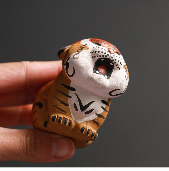 This is a Yixing purple clay tiger teapet