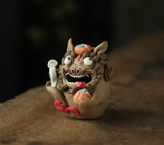 This is a pottery incense holder tea pet