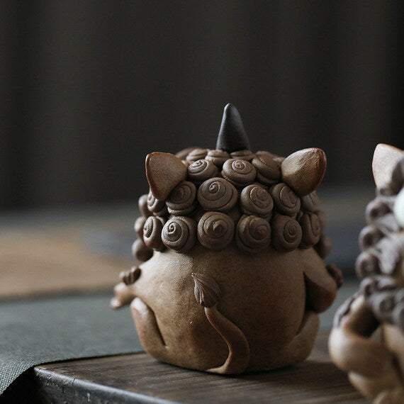 This is a pottery incense holder tea pet