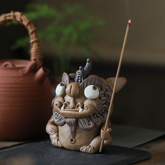 This is a pottery incense holder tea pet