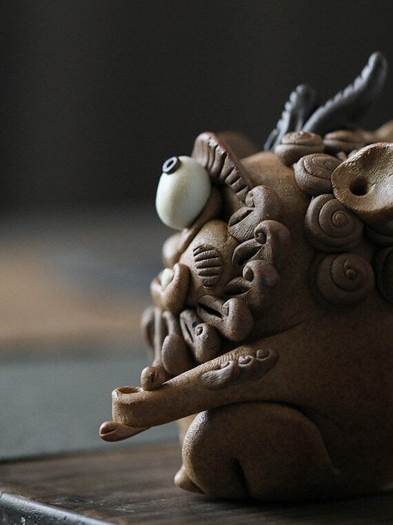 This is a pottery incense holder tea pet