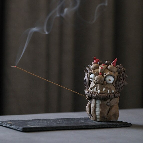 This is a pottery incense holder tea pet