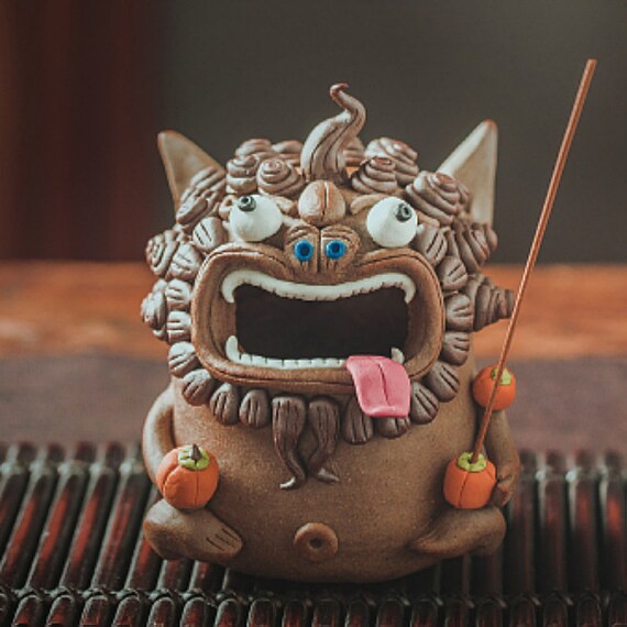 This is a pottery teapet incense holder 