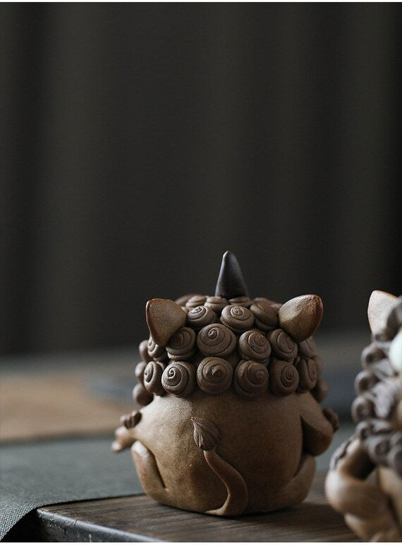 This is a pottery incense holder tea pet