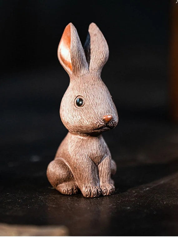 This is a Yixing purple clay rabbit teapet