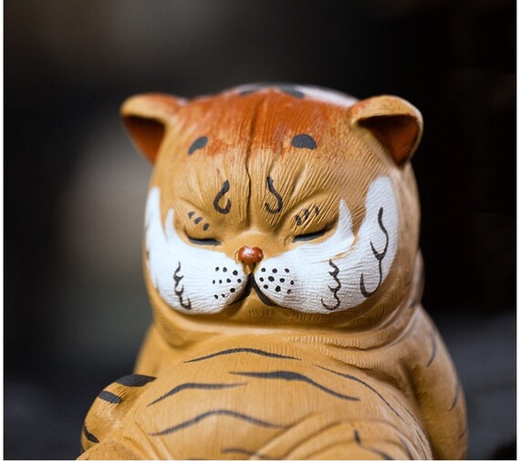 This is a Yixing purple clay tiger teapet