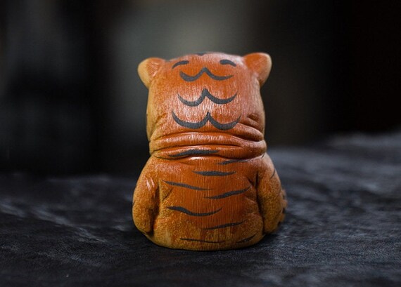 This is a Yixing purple clay tiger teapet