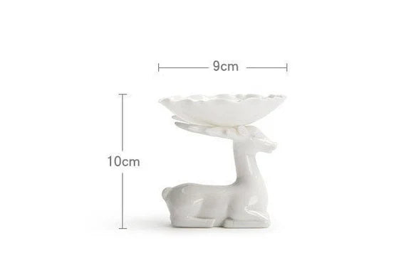 This is a white ceramic tea filter tea funnel