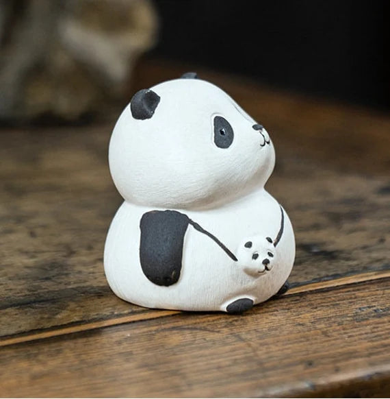 This is a Yixing purple clay panda teapet