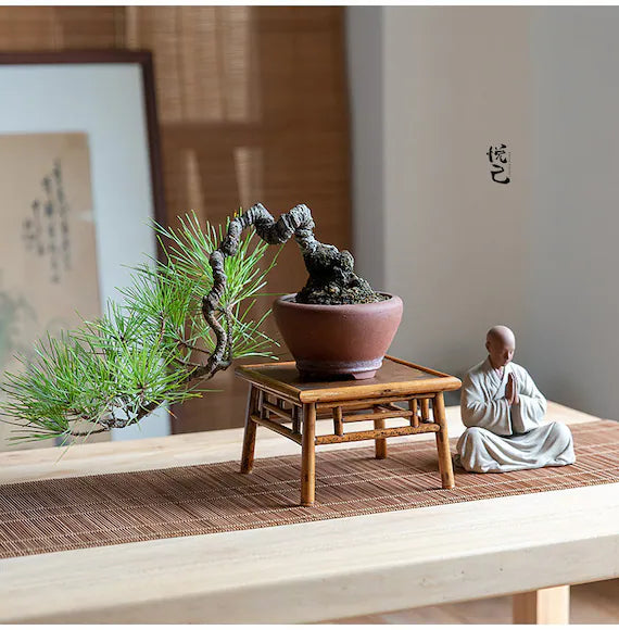 this is a mini pottery monk sculpture