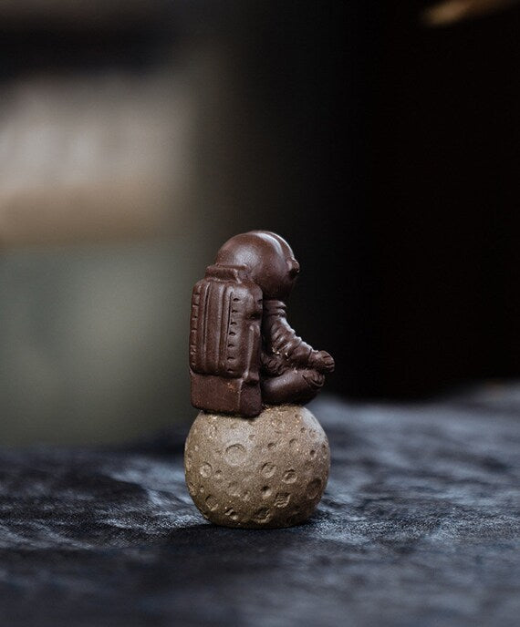 This is a Yixing purple clay meditation astronaut teapet