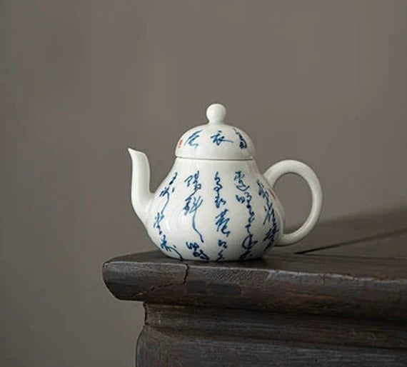 This is a white ceramic teapot